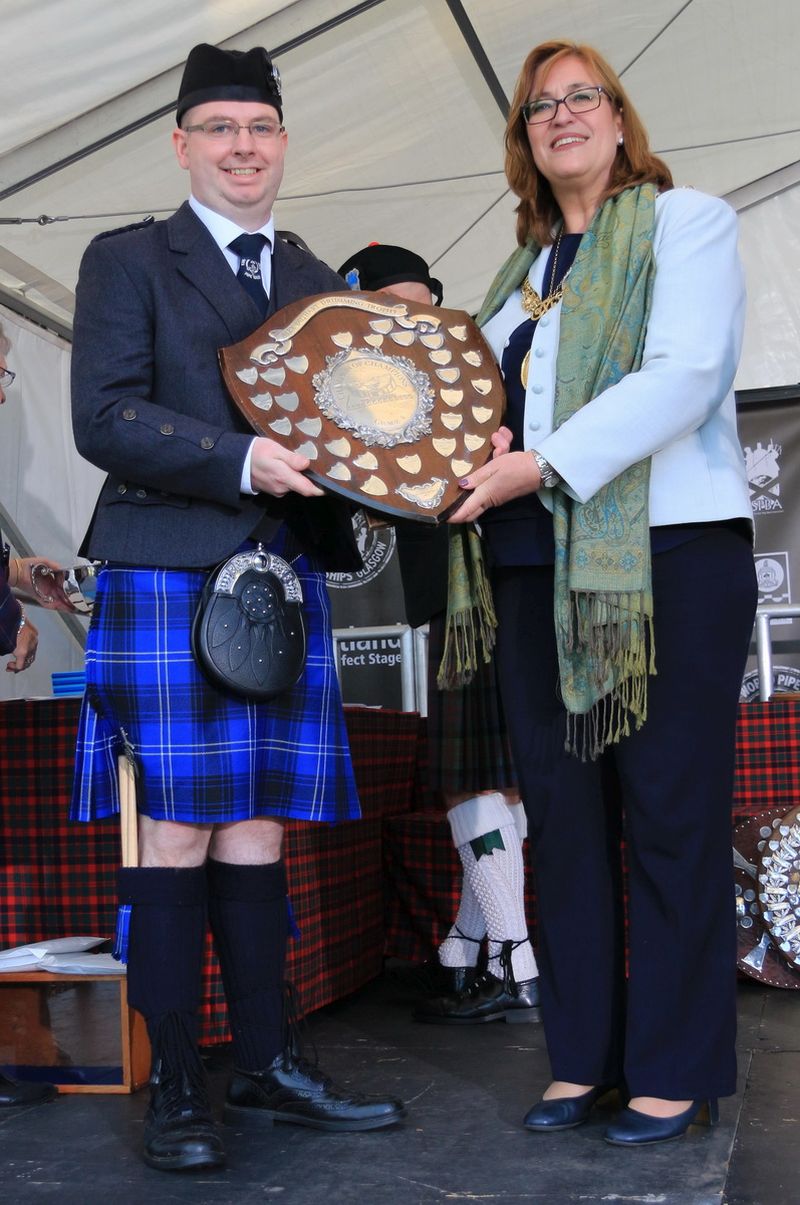Leading Tip Mark Reilly recieving Champion of Champions prize. Looks happy.